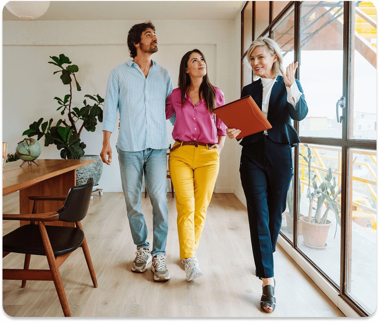 Realtor showing couple a modern apartment.